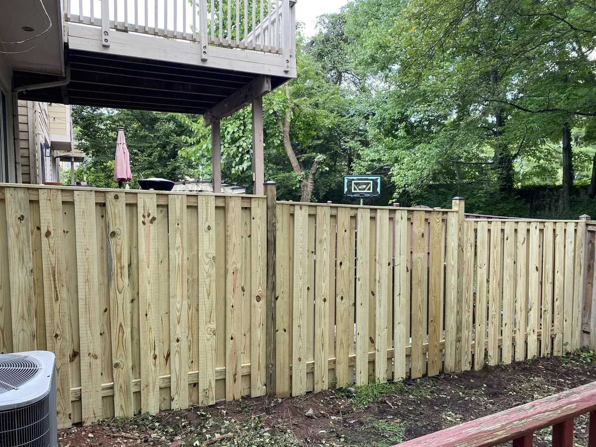New pressure-treated privacy fence installation by Green Leaves